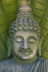 Green stone Buddha statue in Big Buddha Temple, vertical photo of Buddha face