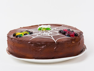 Birthday cake decorated with spider webs, spiders.