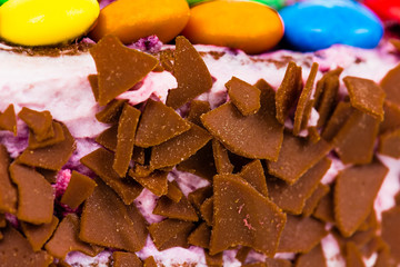 Birthday cake decorated with candy and chocolate.