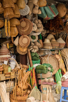 Brooms, baskets and hats for sale at a stall in the Dong Xuan Market, Hanoi, Vietnam
