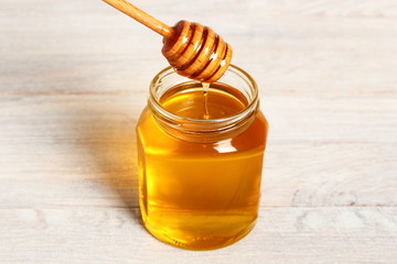 Fototapeta na wymiar Jar of Honey with Honey Dipper