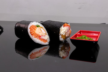 burrito sushi on a black plate