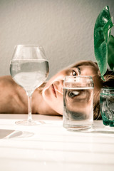 Visual concept. Fashion woman portrait, eye looks through the glass of water. Object distortion,...