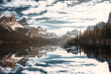 Traveler canoeing in Spirit Island with Canadian Rockies on Maligne lake at Jasper national park