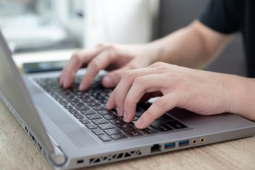 Casual man using modern laptop on desk. stay home, work from home