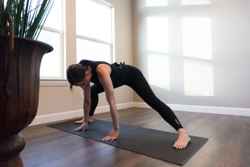 Fototapeta na wymiar Women doing yoga indoors in home 
