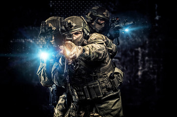 American soldiers in combat ammunition with weapons in the hands of equipped laser sights are in...