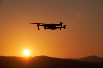 Fototapeta na wymiar Drone flying at the sunset on red sky