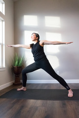 Fototapeta premium Women doing yoga indoors in home 