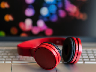 Obraz na płótnie Canvas Headphones close up. Headphones on a laptop keyboard. Telework. Work online. Creation of digital music.