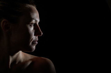 Fototapeta na wymiar Silhouette portrait of a girl isolated on a dark background