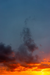 Colourful evening sky painted with red, orange, blue, grey, pink colours