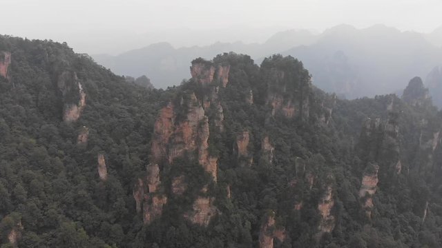 Aerial pan shot over the "Avatar" movie mountains in Zhangjiajie Forest Park, China 