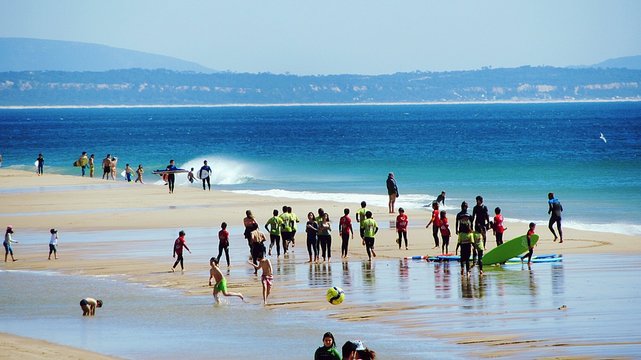 Group Of Surfers On Beach