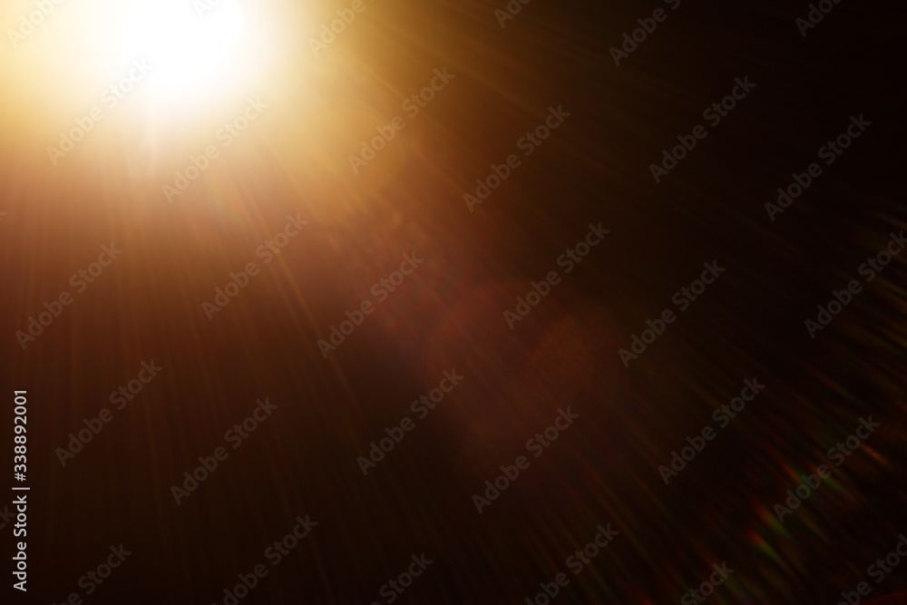 Fototapete Easy to add lens flare effects for overlay designs or screen blending mode to make high-quality images. Abstract sun burst, digital flare, iridescent glare over black background.