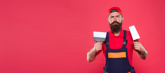 Successful renovation. Repair success. Bearded man worker with plastering tools. Plasterer hipster...