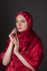 mysterious beautiful woman in the red silk dress of the Eastern Muslim peoples