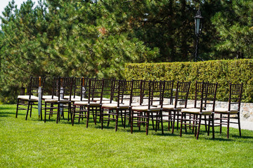 Rows of chairs for guests at an open-air wedding ceremony.