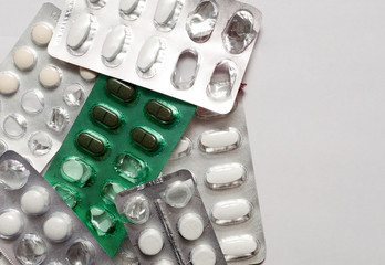 pills in packages on a light background, health products