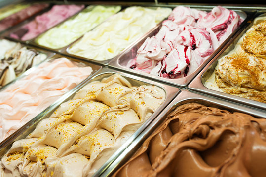 Various Gelato In A Store Window. Multicolor Ice Cream Rack In A Snack Bar