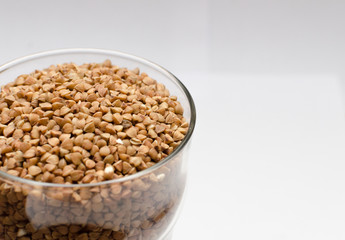 buckwheat groats on a light background, closeup texture