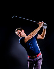 Close-up of a golf player intent on perfecting the swing isolated on dark background, vertical image