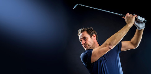 Close-up of a golf player intent on perfecting the swing isolated on dark background, banner image