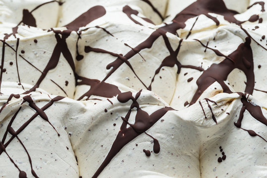 Stracciatella flavour gelato - full frame detail. Close up of a white surface texture of stracciatella Ice cream covered with chocolate stripes and dots