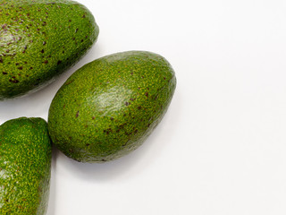 ripe green avocado on a light background