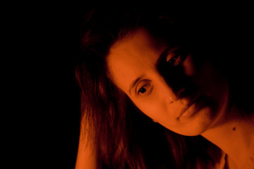 portrait of a girl in red light on a black background