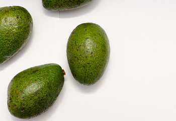 ripe green avocado on a light background