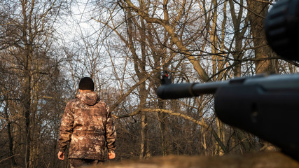 Ambush sniper aims at a man