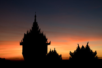 Fototapeta na wymiar Silohuettes of outer buildings at Shwedagon Pagoda at sunrise in Yangon, Myanmar