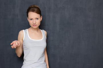 Portrait of dissatisfied indignant blond girl rebuking somebody