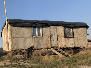 Home made house for the poor. Mobile housing for builders. Old rusty trailer for housing.