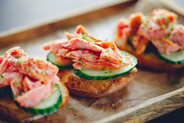 Toasts with fresh cucumber and smoked salmon served with lime shavings.
