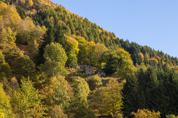 old alpine village built on top of a mountain. Bell towers,Houses and stone roofs