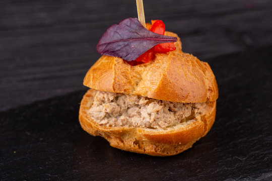 Canape with a pate of chicken, beef and duck, served in ecklers with greens