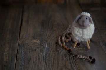 .toy lamb on wooden background..sacrifice feast concept