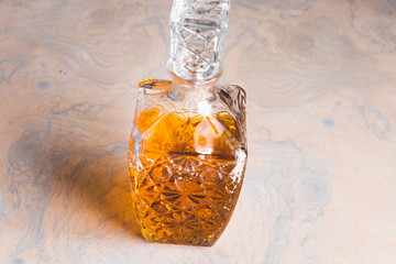 Whiskey decanter hall-full with whisky liquor on table