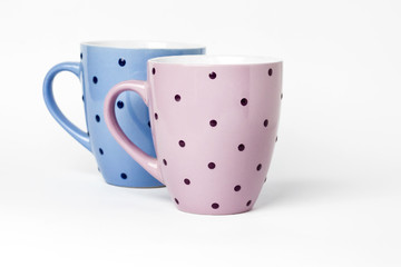 Two dotted teacups isolated on white background