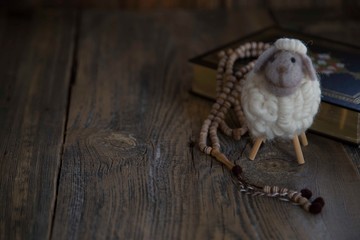 .toy lamb on wooden background..sacrifice feast concept