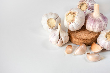 Garlic bulbs and garlic cloves on a white background.