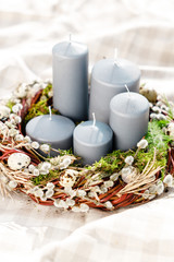 candles in Easter wreath with willow branches in a basket