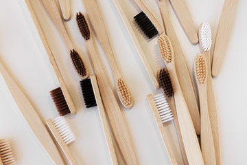 Group of eco bamboo toothbrushes, on white background. Different color. Top view, copy space....
