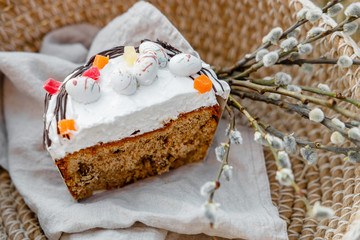 Cut Easter bread and eggs with willow blossom and chocolate eggs - orthodox Russian kulich