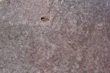 Natural stone of brown color with a chipped uneven texture background