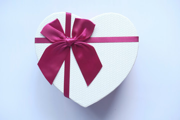 Red heart shape gift box isolated on white.