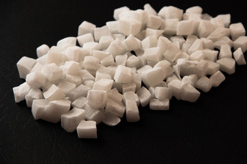 Coconut candied fruit on a black shiny background