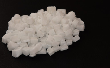 Coconut candied fruit on a black shiny background